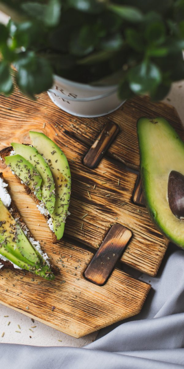 Unusual,Wooden,Plate,On,Which,Lies,Half,An,Avacado,And